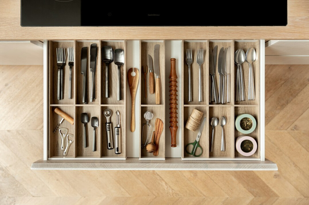 woman organizing kitchen drawers